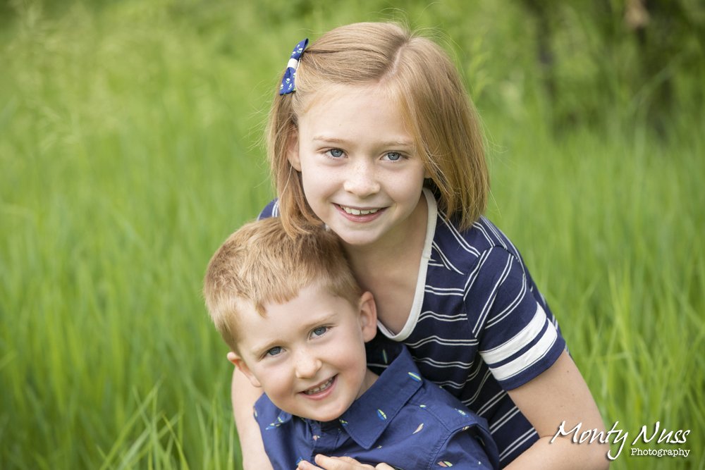 siblings navy blue white green tall grass park bow