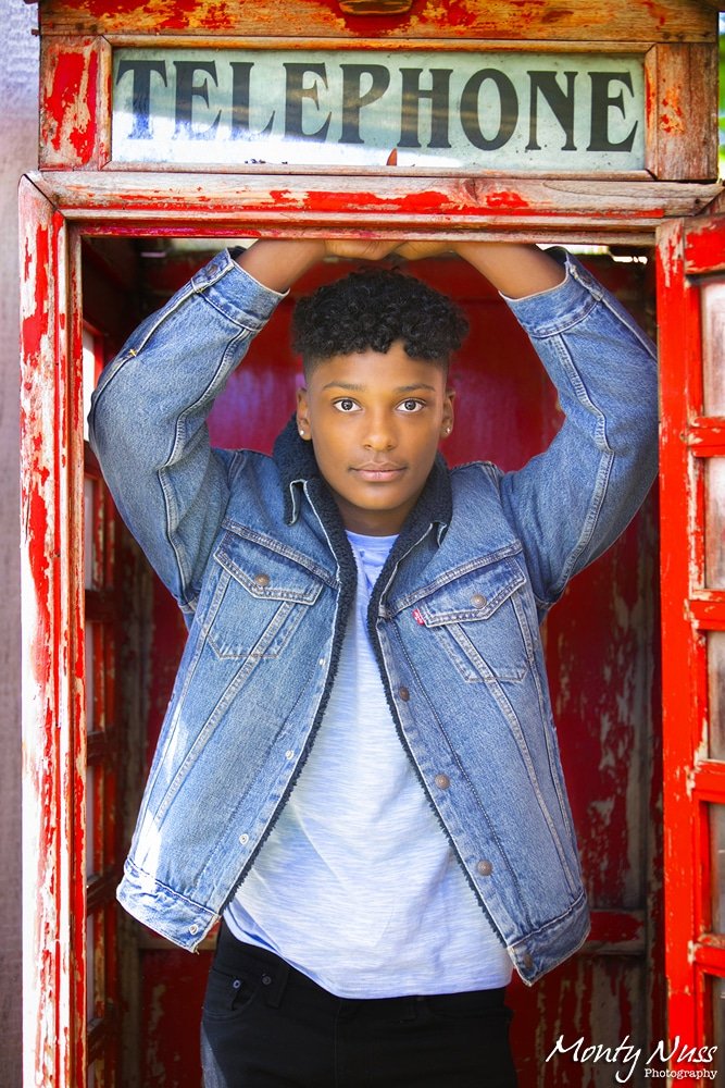 old red telephone booth jean jacket curly hair boy senior littleton photography
